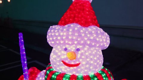 Holiday snowman with many lamps, closeup view in motion