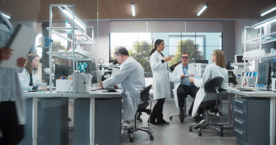 Multiethnic Medical Supervisor Having a Conversation with Caucasian Scientists About Cloning and Other Research Projects, Gene Editing Technology and Experiments. Smart Diverse Team Working in a Lab