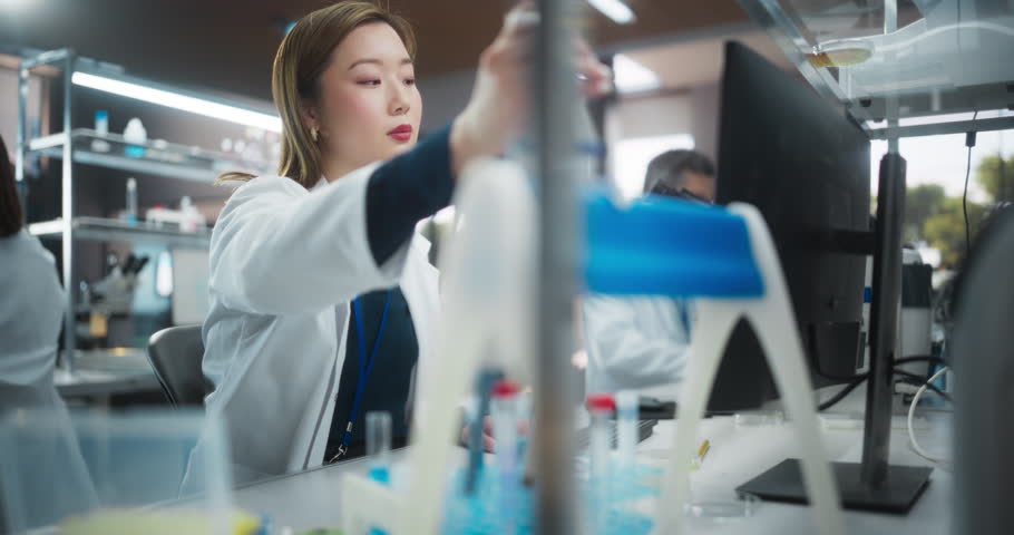 Portrait of a Beautiful Asian Female Scientist Using Micro Pipette for Medical Research Project. Advanced Scientific Lab for Medicine, Biotechnology, Microbiology Development