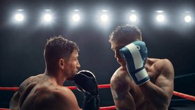 Cinematic Super Slow Motion Sports Footage with Two Professional Boxers Fighting in a Ring. Male Athlete Punching the Opponent in the Face. Sweat Spraying Everywhere From the Heavy Impact - Powered by Shutterstock - Get 15% off with code: PIKWIZARD15