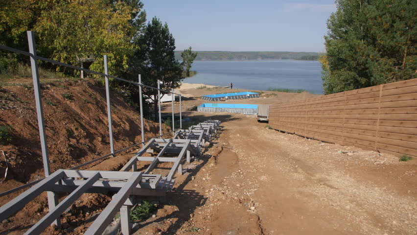 Building of steps leading to beach recreation area. Steel frame prepared for future construction of staircase against backdrop of lake