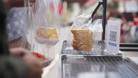 Young Asian man and woman buying and eating street food at railway station with using mobile app on smartphone scan QR code making online payment during travel local town on summer holiday vacation - Powered by Shutterstock - Get 15% off with code: PIKWIZARD15