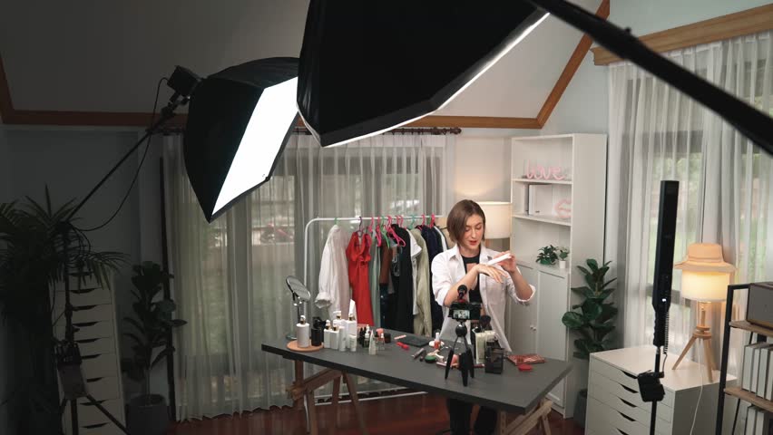 Woman influencer shoot live streaming vlog video review skincare for prim social media or blog. Happy young girl with cosmetics studio lighting for marketing recording session broadcasting online. Royalty-Free Stock Footage #3477161709