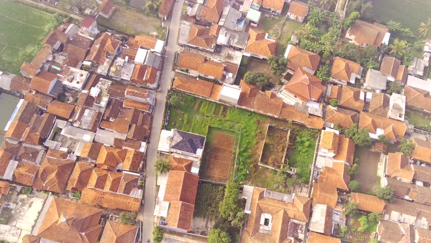 Misty view in the middle of rice fields and settlements. Aerial view of the Rancaeekek area during fog, Bandung - Indonesia. Natural conditions. Above. Aerial Landscapes. Shot in 4K Resolution