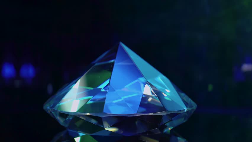 The rotation of a blue-colored and reflective diamond stone epitomizes opulence and sophistication. HDR, 4K. Royalty-Free Stock Footage #3477264493
