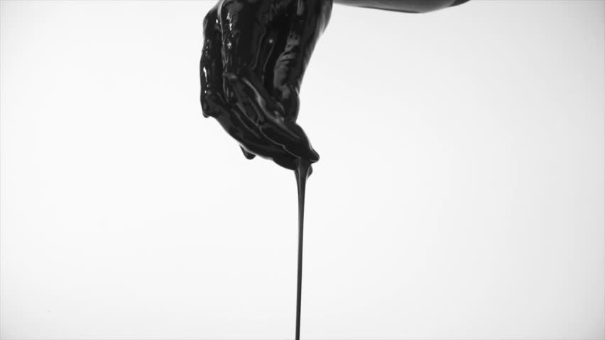 human hand covered in dark black paint dripping off of it in reverse motion climbing towards the hand with a white background STATIC SHOT