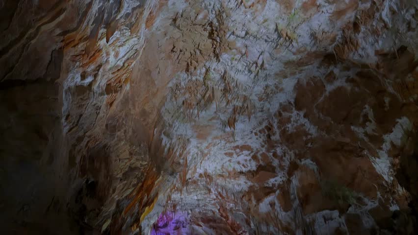 Prometheus (Kumistavi) cave near Tskaltubo and Kutaisi. Imereti Region. Natural monument with hanging stone curtains, stalactites and stalagmites, colorful illuminated rock formations.