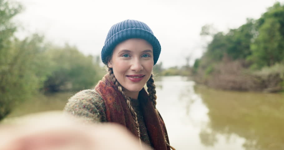 Live stream, camping and woman at lake with travel channel, adventure or outdoor countryside vacation. Influencer, streamer or content creator on holiday in nature with social media, post or vlogging