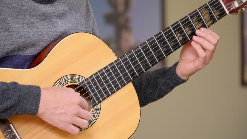 Close-up shot of a man playing a classical guitar Royalty-Free Stock Footage #3477334121