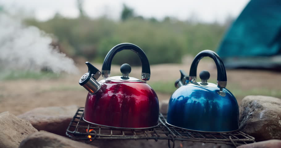 Camping, kettle and fire with smoke outdoor, steam or vapor with heat for boiling water or tea to drink. Adventure, travel and pot for warm beverage or cooking, campfire and vacation in nature park