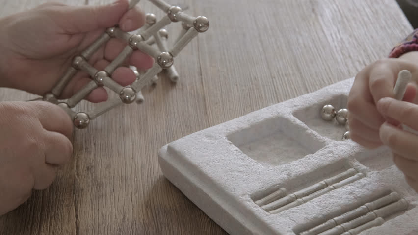 mother and child together assemble structures from magnetic constructor parts, development abstract, spatial thinking, child's imagination, engineering, fine motor skills