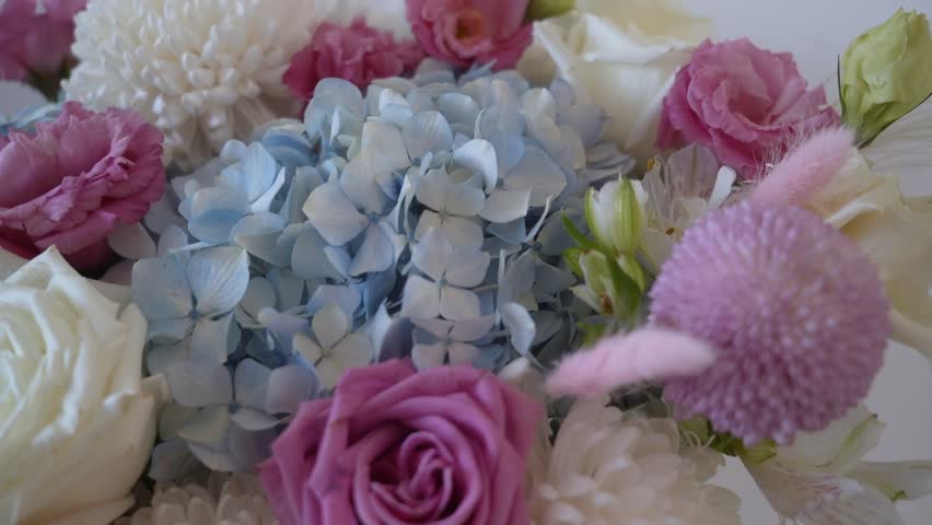 A combined bouquet of different types of flowers in close-up, beautiful dried flowers in a gift bouquet. Beautiful bouquet of flowers in pastel shades.  Royalty-Free Stock Footage #3477400051