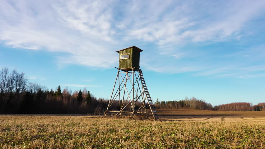 Tall hunting tower with stairs in low angle dolly in shot