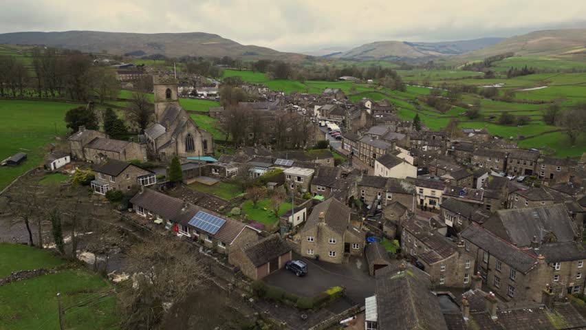Aerial Video of Hawes Yorkshire Dales. The rural market town of Hawes is one of England’s highest, set 850 feet above sea water. Royalty-Free Stock Footage #3477497705