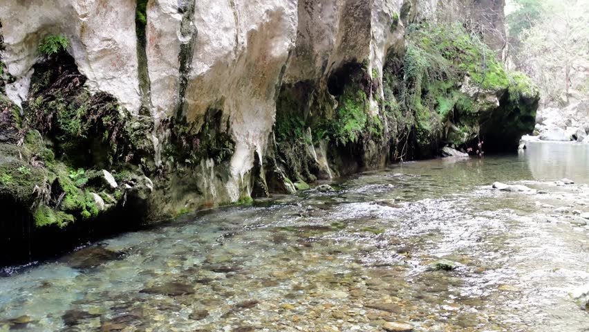 Hidden canyon, cliff lined with fresh running water. Explore serene canyon, cliff landscapes. Discover tranquil canyon, cliff beauty, a natural retreat