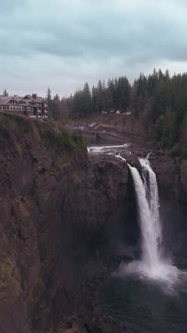 Vertical video. The majestic Snoqualmie Falls with the iconic Salish Lodge overlooking the natural wonder, a popular destination in the Pacific Northwest. Footage 4K. 