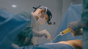 Doctor man surgeon medic physician perform medical surgical abdominal belly operation plastic surgery liposuction procedure nurse hold syringe inject anesthesia in hospital clinic medicine health care - Powered by Shutterstock - Get 15% off with code: PIKWIZARD15