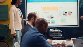 Employees team sharing insight on sales statistics in corporate briefing meeting, providing initiatives to enhance operational efficiency and agility. Group of business associates. Camera A. - Powered by Shutterstock - Get 15% off with code: PIKWIZARD15