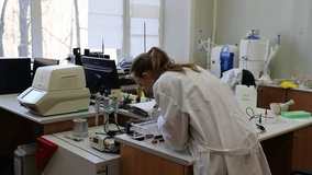 Scientist puts samples with DNA fragments into agarose gel for separation of DNA fragments for electrophoresis - Powered by Shutterstock - Get 15% off with code: PIKWIZARD15