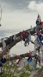 Vertical video. A dry tree high in the mountains of Turkey adorned with amulets to ward off the evil eye.