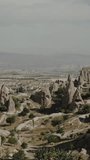 Vertical video. Ancient stone city in Turkey, houses carved from stone, and inside them.