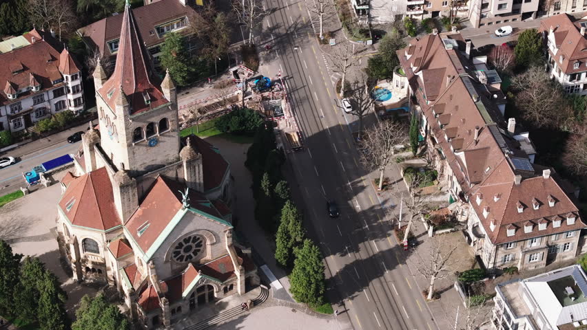 High angle view of streets and buildings in residential urban neighborhood on sunny spring day. St. Pauls Church with tower. Basel, Switzerland