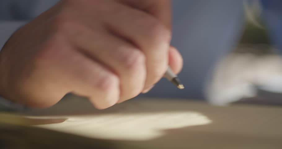 Person Writing On Yellow Notepad, Close Up on Pen to Paper, Office Work, Taking Notes