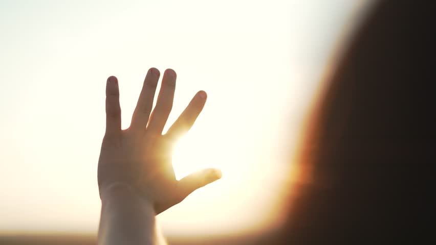 Silhouette of a happy dreaming girl pulls her hand to the sun. Religion helping hand. Happy girl pulls her hand. Prayer in religion. Silhouette of a hand in the sun. Happy girl silhouette at sunset Royalty-Free Stock Footage #3477690349