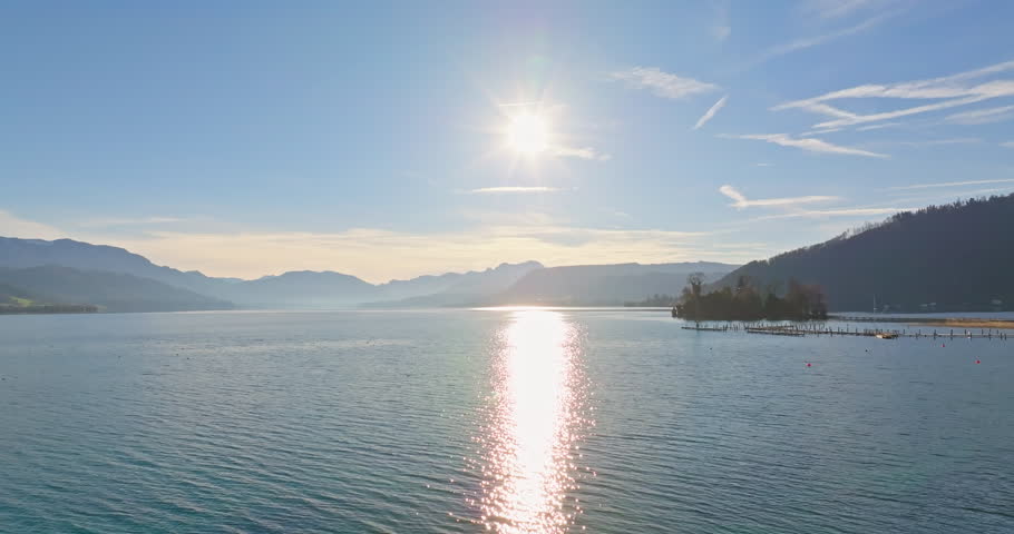 Aerial view landscape of Lake Traunsee in the Austrian Alps. Beautiful sunny nature of the lake at the foot of the mountain ranges. High quality 4k footage