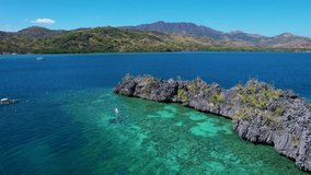 4K Aerial drone video of Siete Pecados Siete with boats surrounded by blue sea. Coron, Palawan. Philippines.