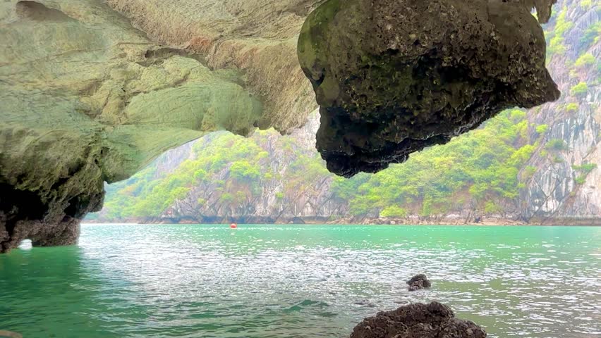 Cruising out of Dark and Light Cave in Lan Ha Bay and Ha Long Bay area in Vietnam in sampan fishing boat
