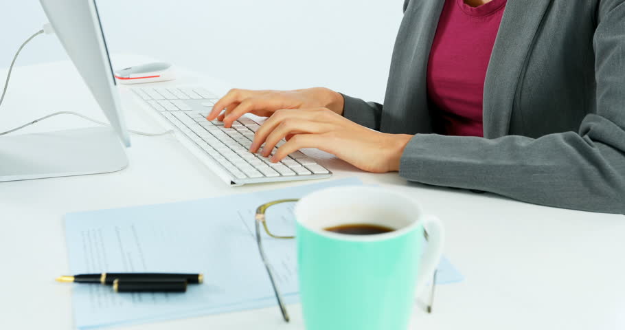 Businesswoman working at desk against white background 4k