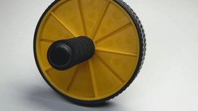 yellow black exercise wheel isolated on white background