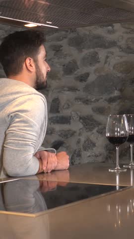 A couple having a glass of wine in the kitchen of their home, lifestyle of a couple in a romantic moment. 4k video Royalty-Free Stock Footage #3478044483