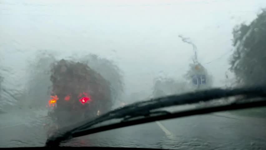 a trip in a car in heavy rain, a view from the car window. Car wipers work Royalty-Free Stock Footage #3478044801