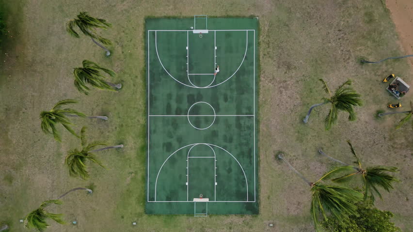 Cinematic aerial of basketball outdoor course on ocean shore in Oahu Island, Honolulu, Hawaii. High quality 4k footage