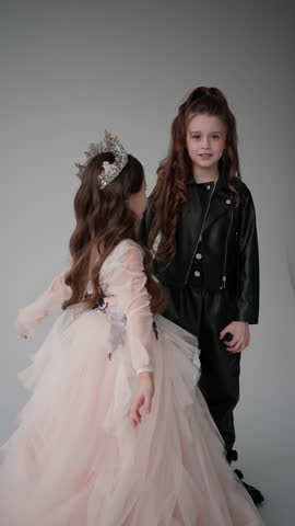 Joyful intimacy as girl in tiara hugs her friend in leather jacket, radiating happiness. Concept of joyful unity