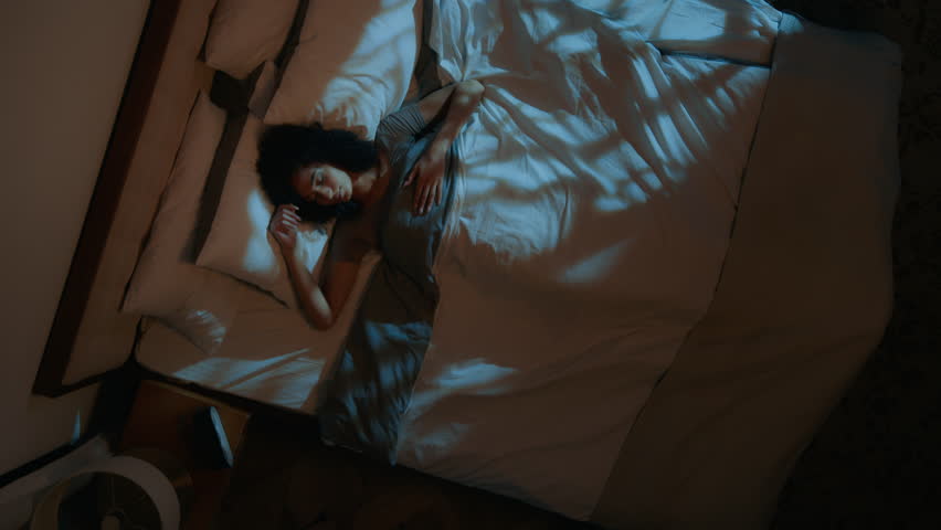 Top view above African American woman sleeping under duvet comfortable bed soft cozy mattress pillow sleepy female girl napping insomnia night sweet dreams relaxing healthy nap sleep in home bedroom Royalty-Free Stock Footage #3478165795