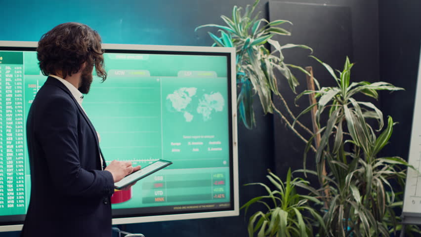 Chief executive officer greeting his employees in a boardroom, starting action review meeting. Manager helps staff members to develop confidence, gain insight and improve themselves. Camera A.