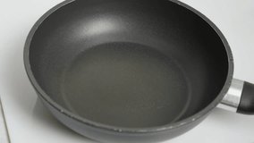The video shows oil pouring onto a heated skillet, ready for frying. Suitable for culinary recipe videos and instructional materials