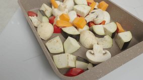 The video features a tray of sliced vegetables, ready for cooking. Perfect for culinary recipe videos and advertising healthy eating