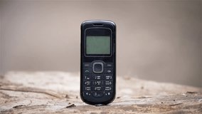 Furious businessman smashes old styles button mobile phone with sledgehammer. Business failures, failed startup, losses and financial incompetence concept - Powered by Shutterstock - Get 15% off with code: PIKWIZARD15