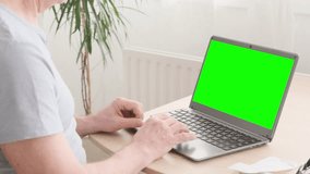 elderly man hesitantly uses laptop, green screen mockup, Senior Lifestyle, representing challenges and opportunities digital literacy for seniors, online communication	