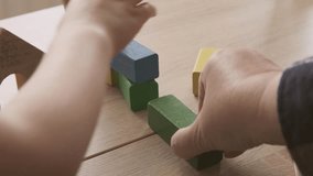 smart child playing with educational toy, wooden geometric figures, blocks in 5-year-old girl's hands, developing brain games, mother playing with daughter, childhood, child development, creativity - Powered by Shutterstock - Get 15% off with code: PIKWIZARD15