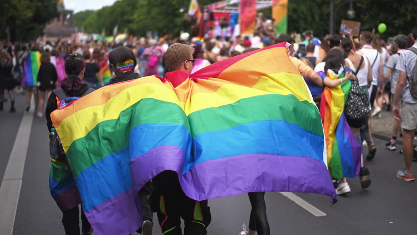 People enjoy lgbt pride parade. Same sex love concept. Dressed up bi men wear rainbow flag. Joy free gay go walk city street. Happy csd lgbtq fest. Fun coming out party. Queer culture festival month.