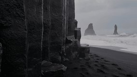 Iceland, Black Sand Beach. Basalt Stacks and Rough Sea Waves in Front of Scenic Cliffs on Stormy Day - Powered by Shutterstock - Get 15% off with code: PIKWIZARD15