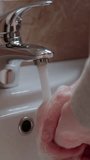 Person practices personal hygiene washing hands hands under water close up vertical video. Personal hygiene vital act helps prevent transmission of harmful bacteria Handwashing is personal hygiene.
