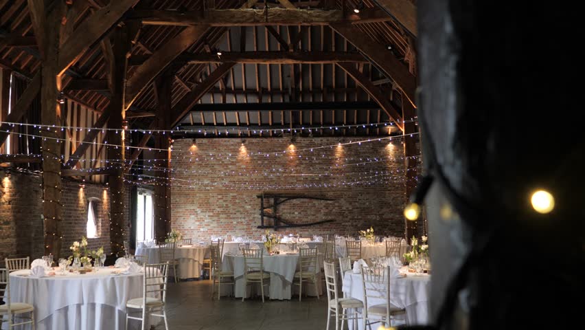 Vertical slider shot revealing wedding setup in an enchanting barn venue Royalty-Free Stock Footage #3478503547
