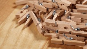 Wood clothespins on wooden background.