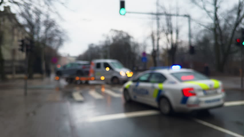 Blurry police car with flashing lights on a street